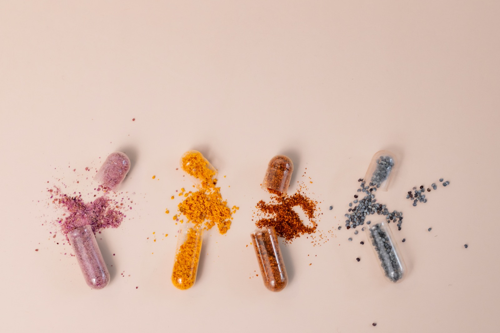 Open capsules revealing their powders and granules